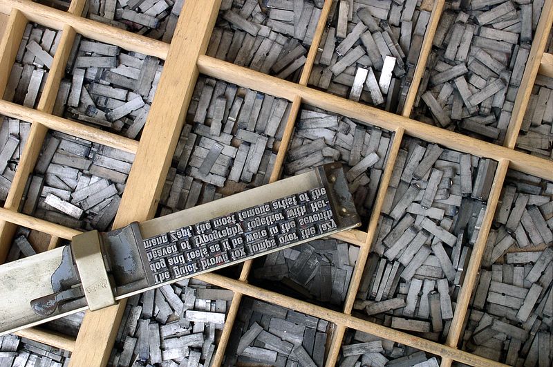 Metal type in a composing stick